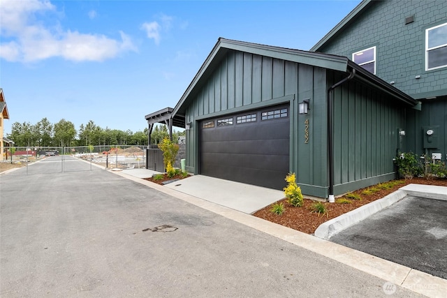 4232 Melrose Ln, Bellingham, WA 98226 - view of home's exterior with board and batten siding, a garage, and driveway