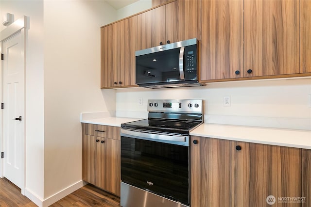 4232 Melrose Ln, Bellingham, WA 98226 - kitchen featuring appliances with stainless steel finishes, brown cabinetry, dark wood-type flooring, light countertops, and modern cabinets
