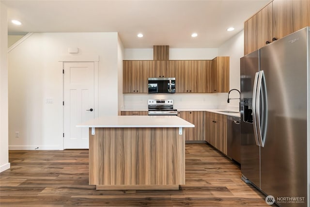 4232 Melrose Ln, Bellingham, WA 98226 - kitchen with stainless steel appliances, a center island, dark wood-type flooring, light countertops, and modern cabinets