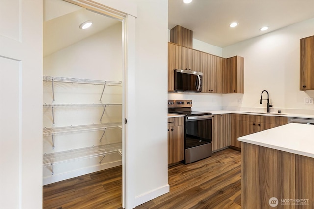 4232 Melrose Ln, Bellingham, WA 98226 - kitchen featuring appliances with stainless steel finishes, dark wood-type flooring, light countertops, recessed lighting, and modern cabinets