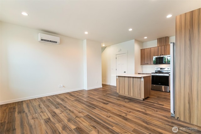 4232 Melrose Ln, Bellingham, WA 98226 - kitchen featuring stainless steel appliances, an AC wall unit, dark wood-type flooring, a center island, and light countertops