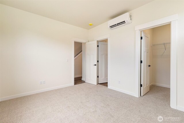 4232 Melrose Ln, Bellingham, WA 98226 - unfurnished bedroom featuring a wall unit AC, carpet, a spacious closet, and a closet