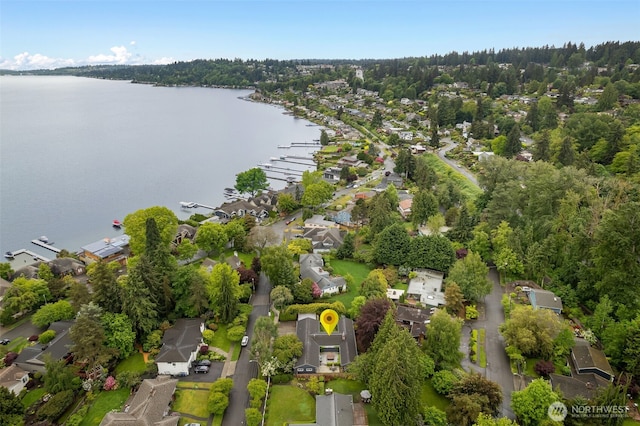 aerial view of property's location featuring a nearby body of water and nearby suburban area