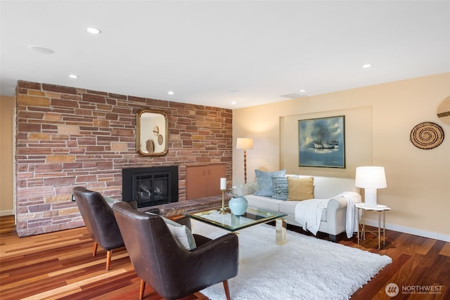 living area with a fireplace, wood finished floors, baseboards, and recessed lighting