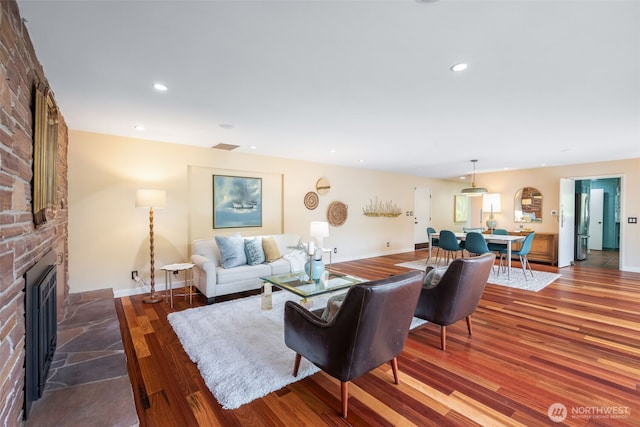 living room featuring a fireplace, wood finished floors, recessed lighting, and baseboards