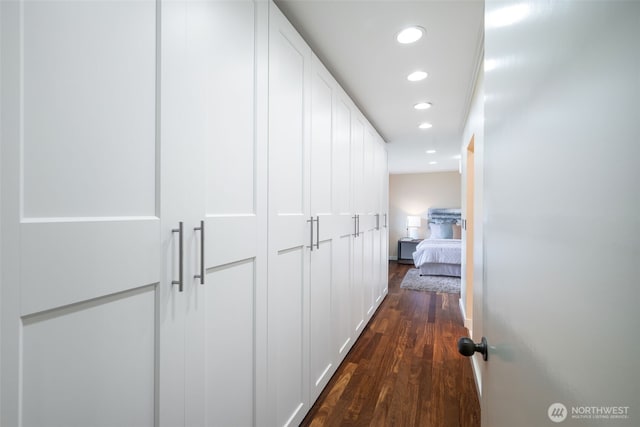 corridor featuring dark wood finished floors and recessed lighting
