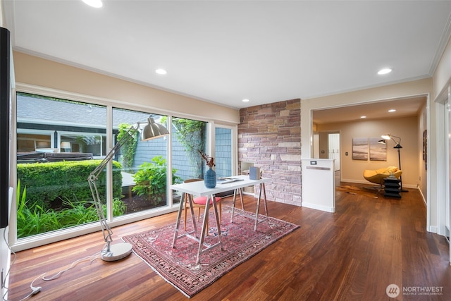 office space featuring dark wood-type flooring, ornamental molding, baseboards, and recessed lighting