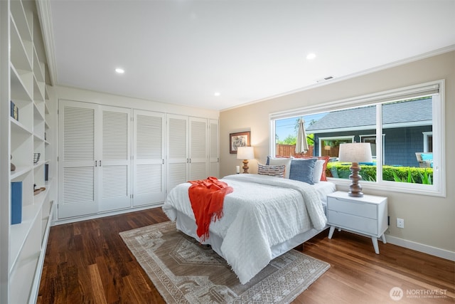 bedroom with wood finished floors, ornamental molding, a closet, baseboards, and recessed lighting