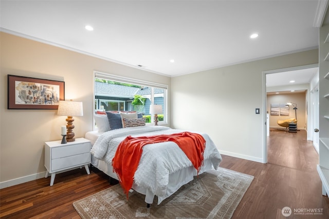 bedroom featuring ornamental molding, wood finished floors, recessed lighting, and baseboards