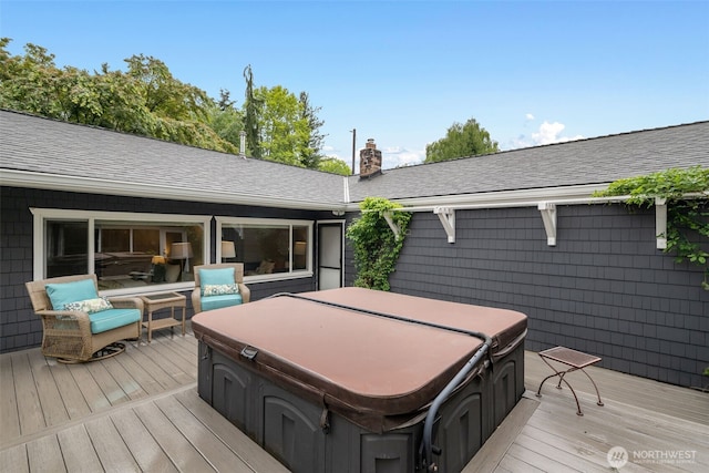 wooden terrace featuring a hot tub