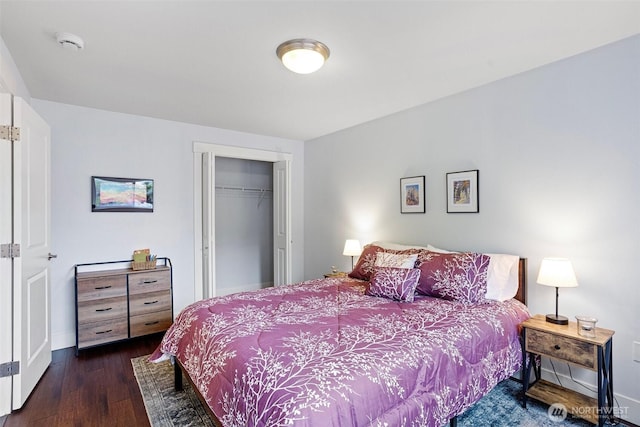 bedroom with baseboards, a closet, and wood finished floors