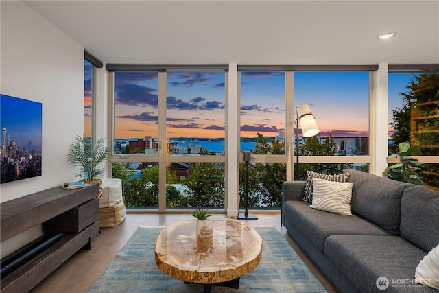 living room featuring recessed lighting, expansive windows, and wood finished floors