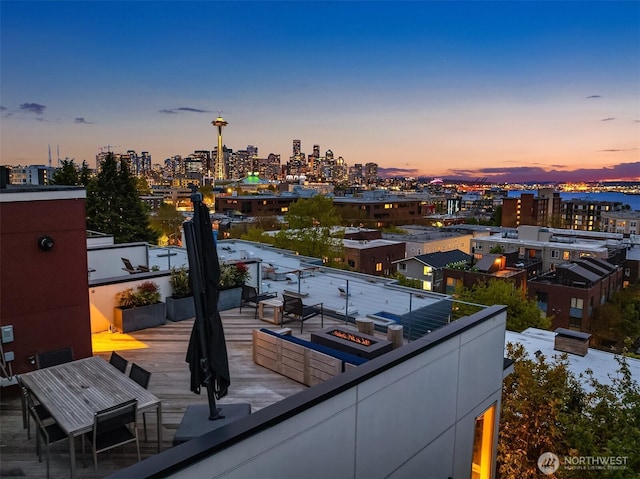 balcony with a city view and an outdoor fire pit