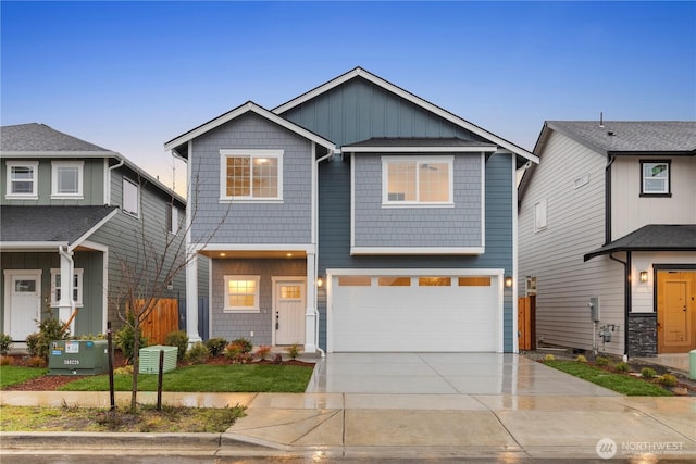 view of front of property with board and batten siding, driveway, and a garage