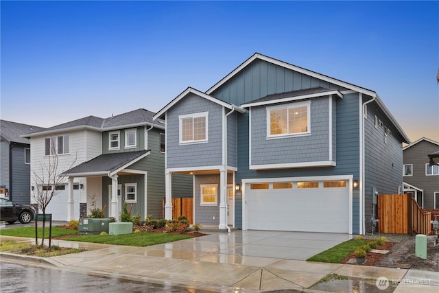 view of front facade featuring a garage, central air condition unit, driveway, and fence