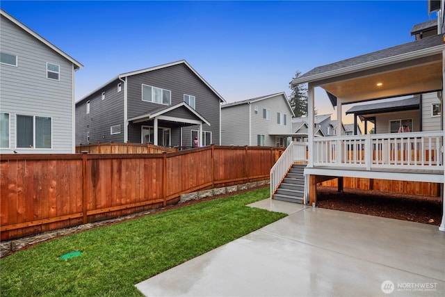 view of yard with a fenced backyard, stairs, a deck, and a patio
