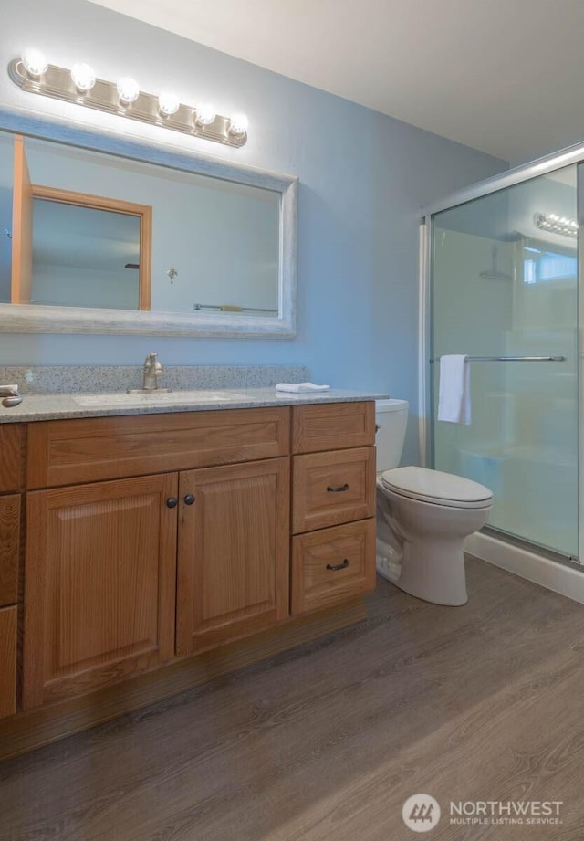 121 E Connemara Way, Shelton, WA 98584 - bathroom featuring a shower stall, toilet, wood finished floors, and vanity