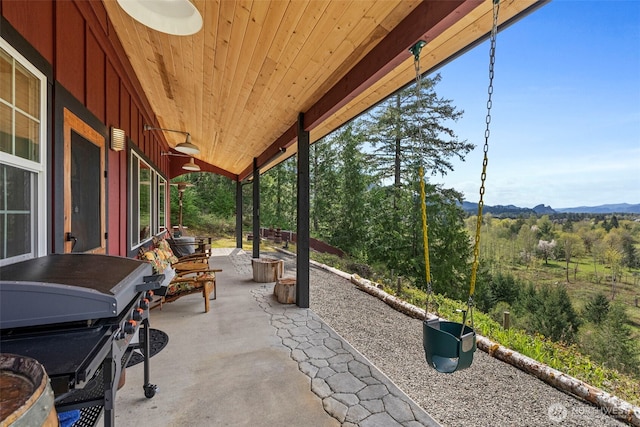 view of patio / terrace featuring a mountain view and a grill