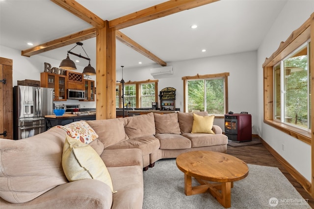 living room featuring beam ceiling, wood finished floors, baseboards, recessed lighting, and a wall mounted AC