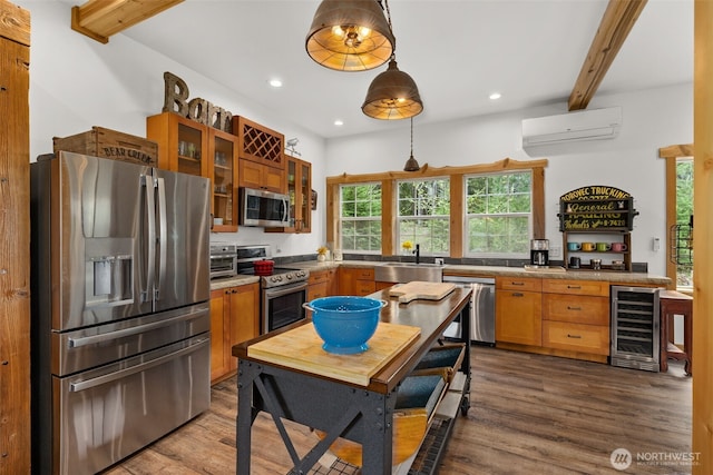 kitchen with a sink, stainless steel appliances, a wall unit AC, wine cooler, and beamed ceiling