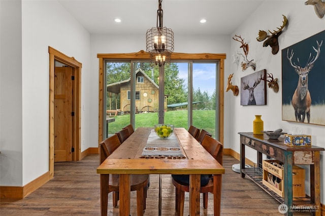 dining space with baseboards, recessed lighting, dark wood finished floors, and a chandelier