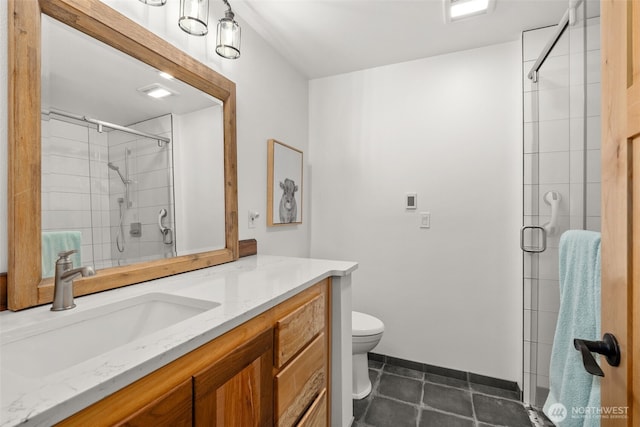 full bathroom featuring vanity, toilet, baseboards, tile patterned floors, and a shower stall