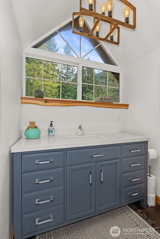bar featuring a sink and lofted ceiling
