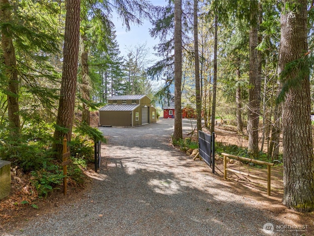 exterior space featuring a gated entry and gravel driveway