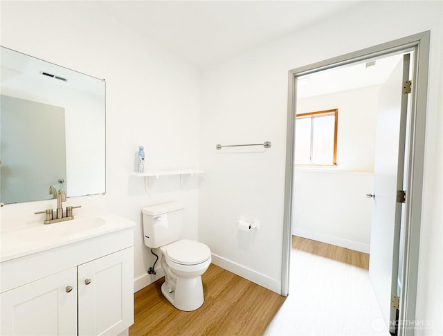 27526 26th Ave S, Federal Way, WA 98003 - bathroom with wood finished floors, toilet, vanity, and baseboards
