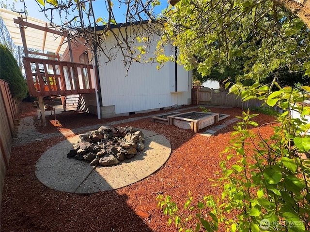 27526 26th Ave S, Federal Way, WA 98003 - view of side of home featuring crawl space, a fenced backyard, a fire pit, and a wooden deck