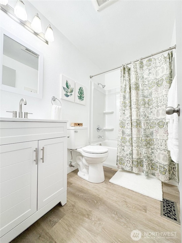 27526 26th Ave S, Federal Way, WA 98003 - full bathroom with wood finished floors, toilet, shower / tub combo, and vanity