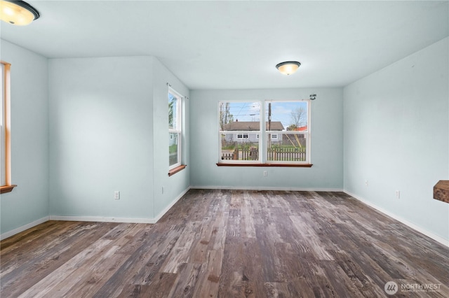 empty room with baseboards and wood finished floors