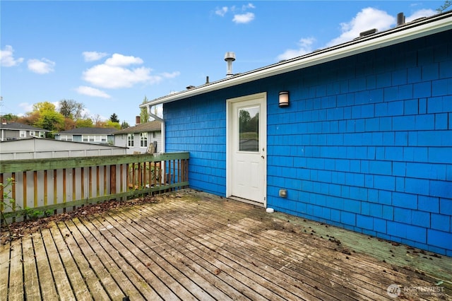wooden terrace featuring fence