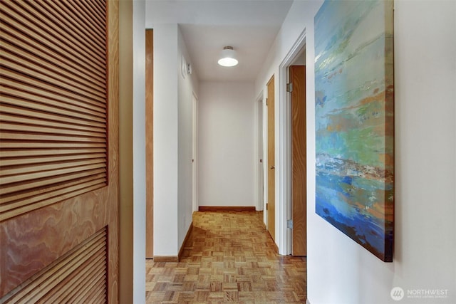 hallway featuring baseboards