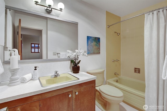 full bath featuring vanity, shower / bath combo with shower curtain, and toilet