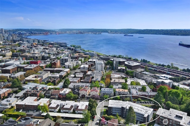 birds eye view of property with a view of city and a water view