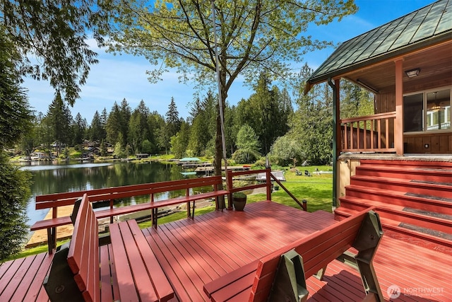 wooden terrace featuring a water view