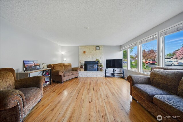 living area featuring light wood-style floors and a textured ceiling