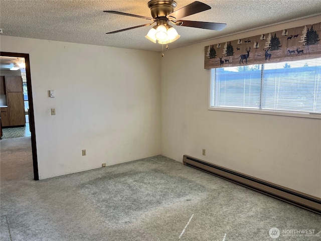 610 W Spruce St, Sequim, WA 98382 - carpeted spare room featuring a baseboard heating unit, ceiling fan, and a textured ceiling