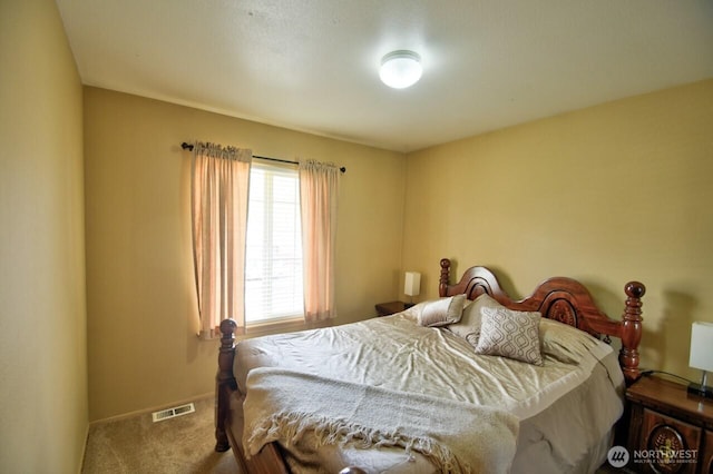carpeted bedroom with baseboards and visible vents