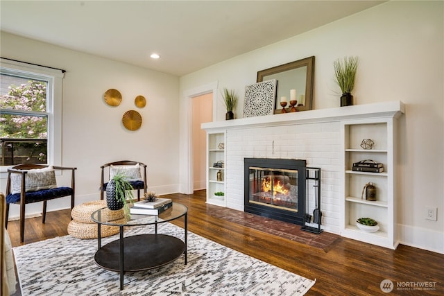 living room with recessed lighting, baseboards, wood finished floors, and a fireplace
