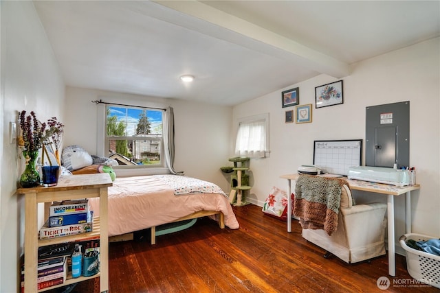 bedroom featuring wood finished floors, electric panel, multiple windows, and beamed ceiling