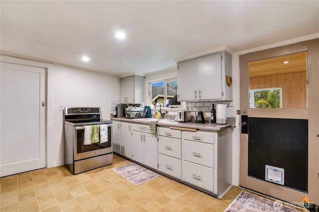 kitchen featuring light countertops, stainless steel electric range oven, recessed lighting, and a healthy amount of sunlight