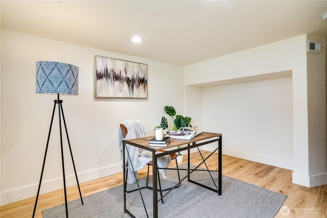office space featuring baseboards, recessed lighting, and wood finished floors