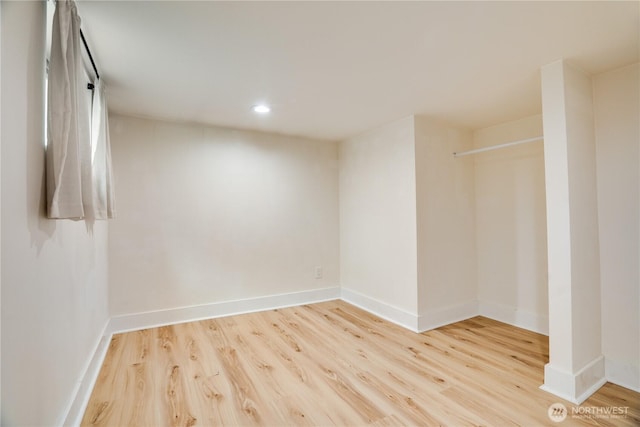 spare room with recessed lighting, baseboards, and wood finished floors