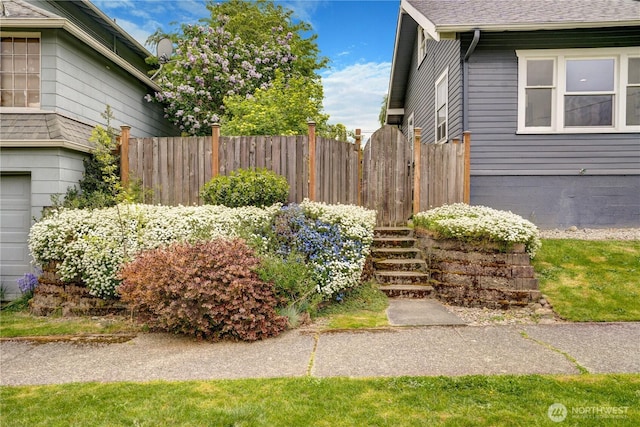 view of side of property featuring fence and a shingled roof