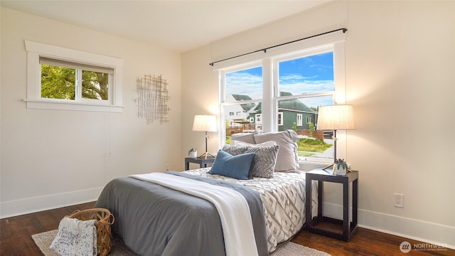 bedroom featuring baseboards and dark wood-type flooring