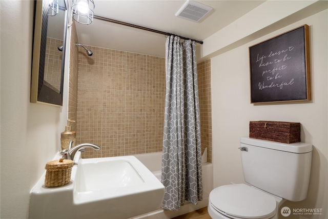 full bath featuring visible vents, shower / tub combo with curtain, and toilet