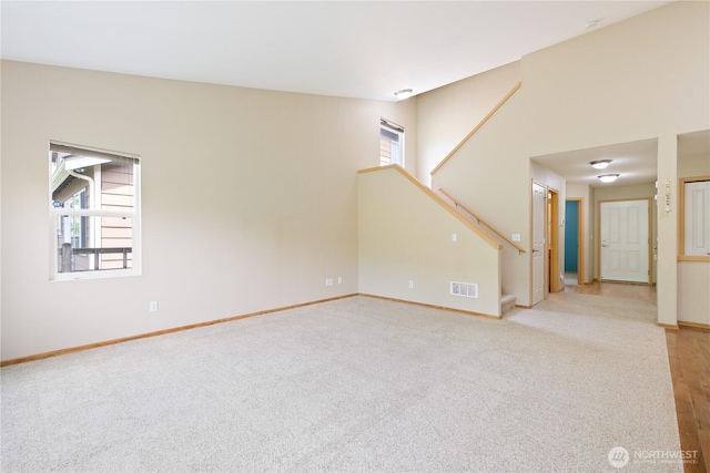 4254 Roxanna Loop SE, Lacey, WA 98503 - empty room featuring stairs, baseboards, and light colored carpet
