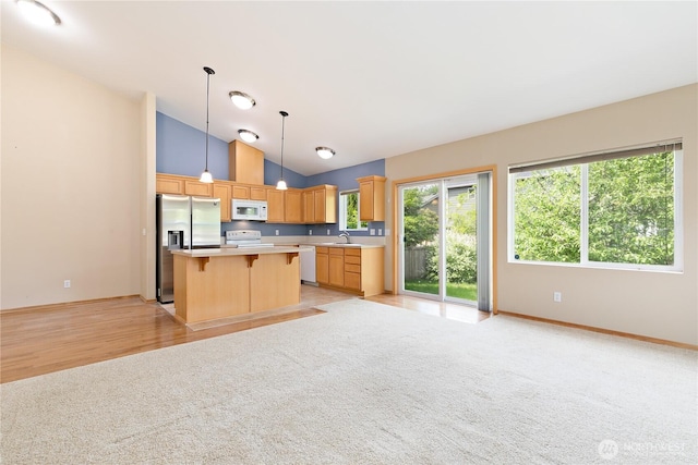 4254 Roxanna Loop SE, Lacey, WA 98503 - kitchen with white appliances, a sink, light countertops, a breakfast bar area, and light carpet